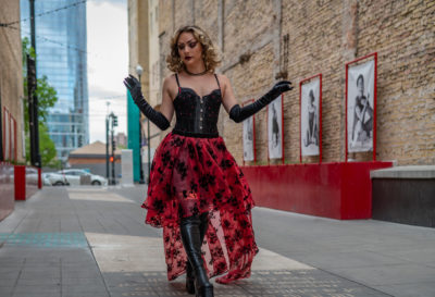 Baby Gorgeous wearing a red skirt in an alleyway