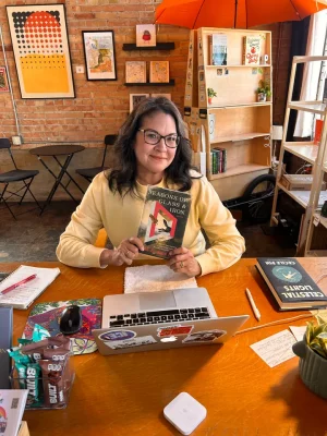 Bookstores owners pose with the book they reviewed