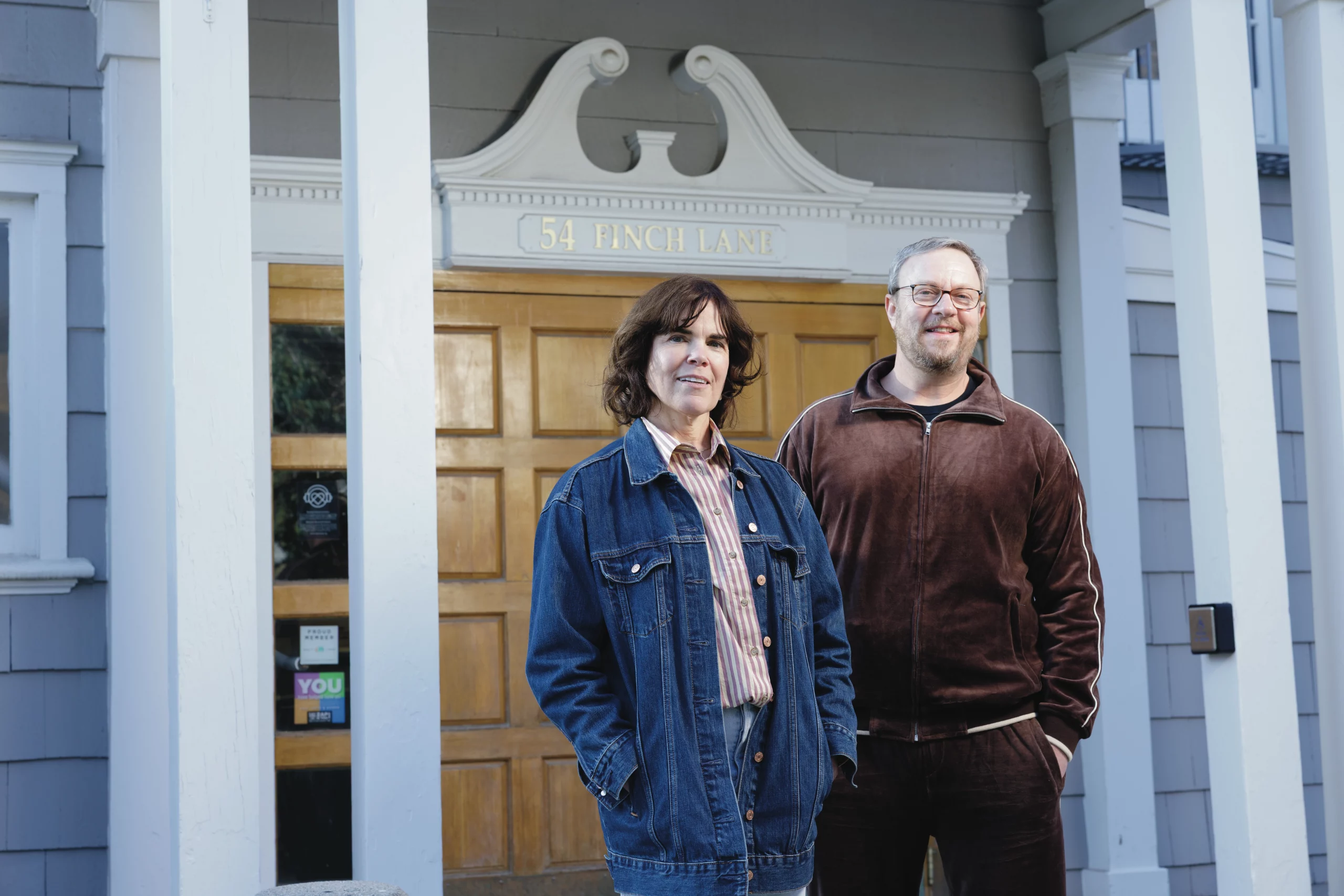 Carol Sogard and Ben Bloch pose in front of the gallery