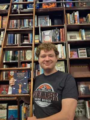 Bookstores owners pose with the book they reviewed
