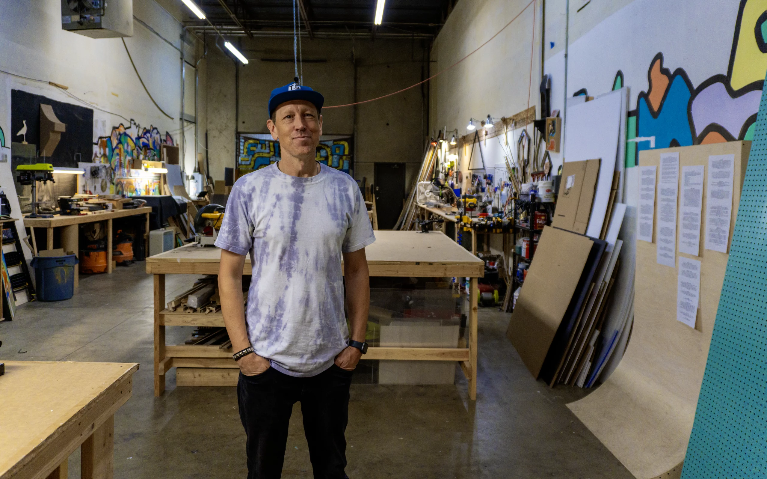 Ryan Harrington, owner of Harrington Art Studio in Midvale, Utah, smiles in his workshop.