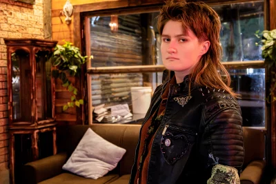 Elijah June poses in a leather jacket
