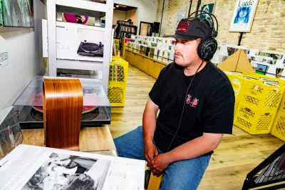 Jake Clements of Honeybee Reviews listening to a record at 3Hive Record Lounge
