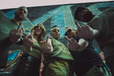 Five bandmates giving a middle finger to the camera.