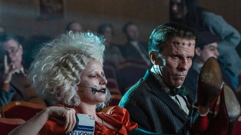 two individuals sitting in a movie theater.